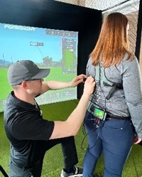 Woman putting on K-Vest to track golf swing